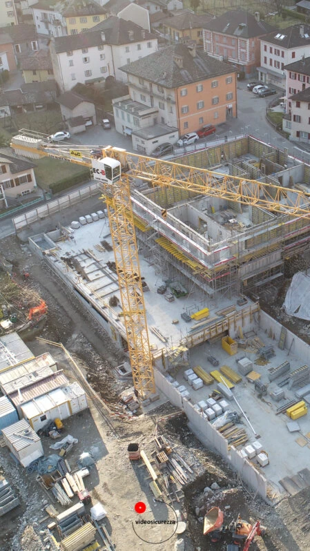 Ripresa aerea con drone di cantiere edile urbano Ripresa dall’alto di un cantiere in costruzione con gru e strutture in cemento armato, in centro abitato urbano